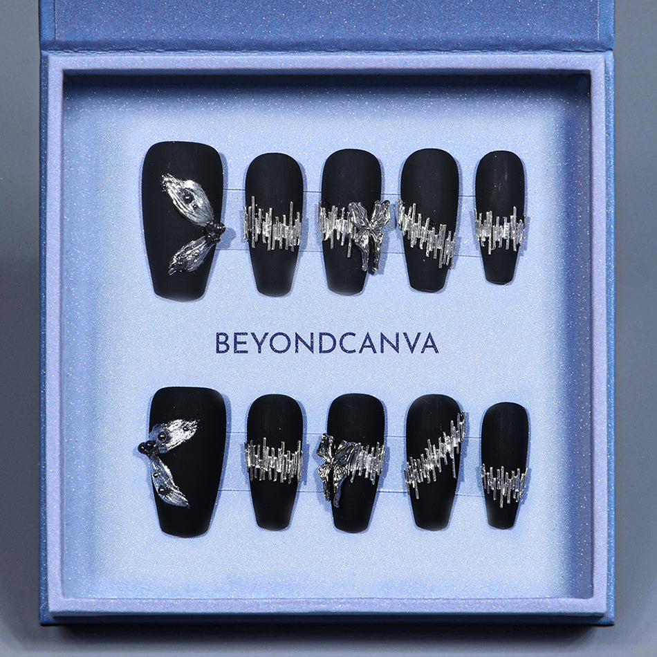 BEYONDCANVA luxury press-on nails set in matte black, embellished with intricate silver accents and 3D details, elegantly packaged in a blue box.