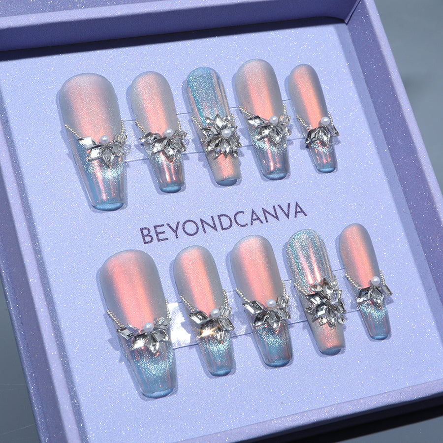 BEYONDCANVA press-on nails in a purple box, featuring shimmery pink and blue designs with 3D pearl and rhinestone accents.