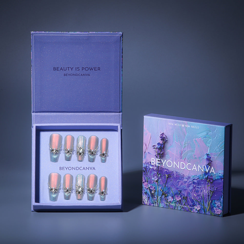 BEYONDCANVA press-on nails in a purple box, featuring shimmery pink and blue designs with 3D pearl and rhinestone accents.