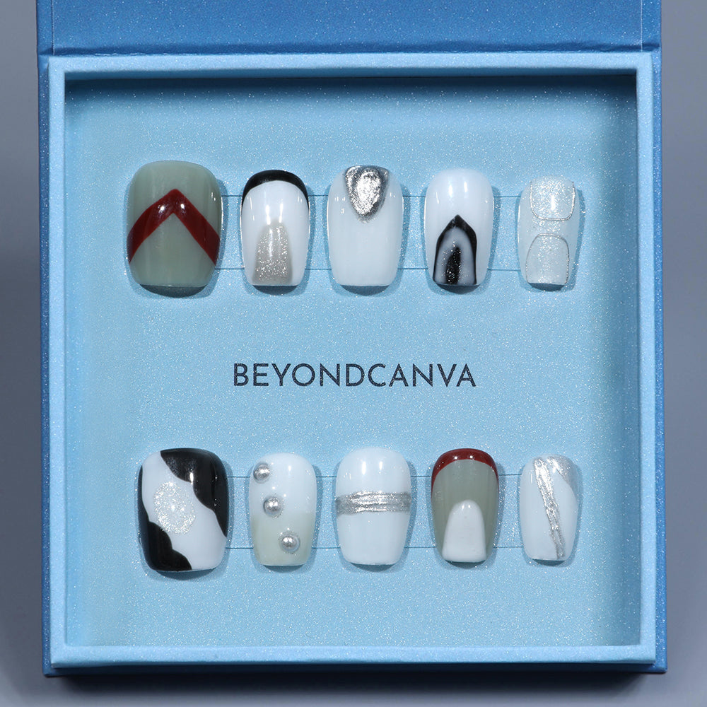 BEYONDCANVA press-on nails set featuring a mix of abstract white, silver, red, and black designs with metallic details, elegantly presented in a blue box.