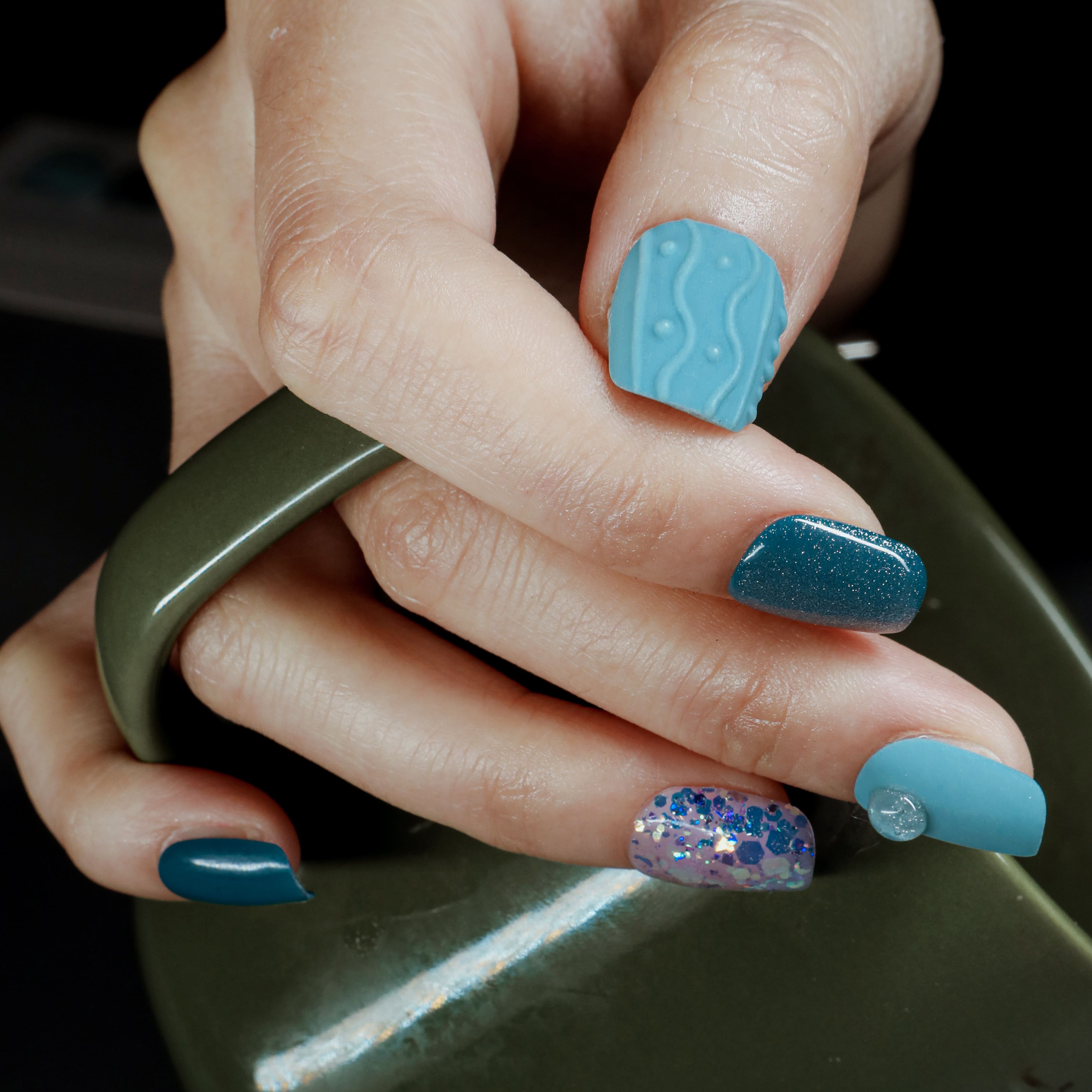 Beyondcanva blue-themed press-on nails featuring unique textures, glitter accents, and a vibrant, bold design.