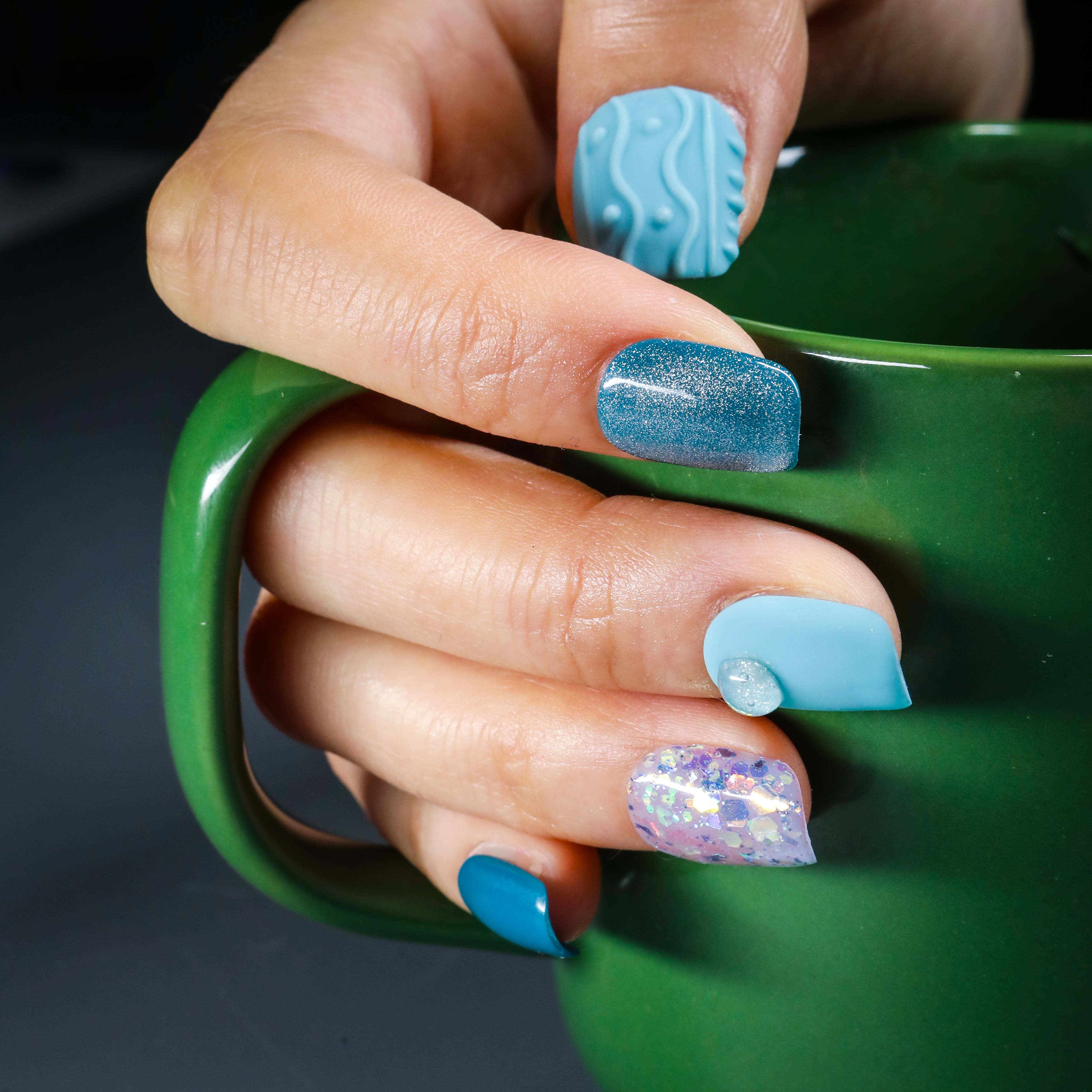 Beyondcanva blue-themed press-on nails featuring unique textures, glitter accents, and a vibrant, bold design.