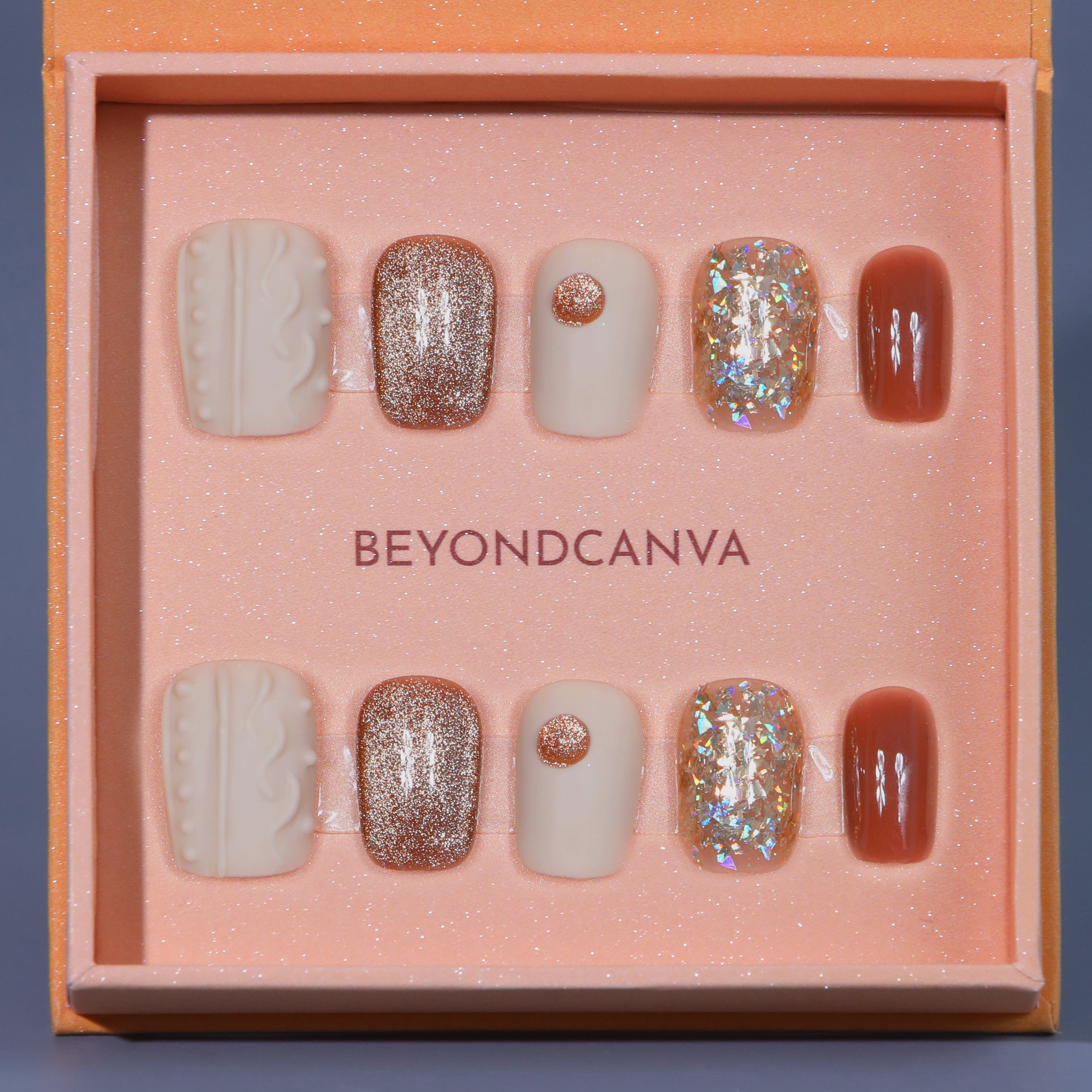 Beyondcanva's press-on nails set featuring elegant beige, glittery rose gold, and shimmering accents, perfect for a chic look.