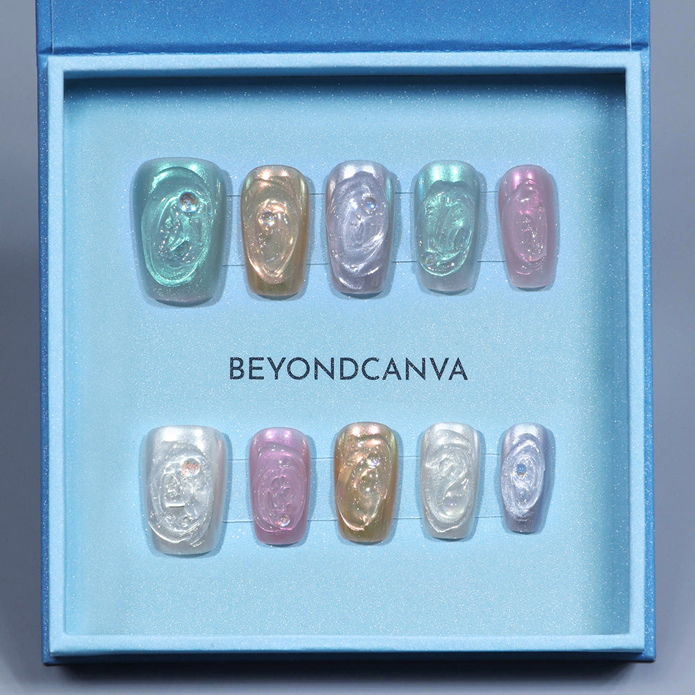 BEYONDCANVA pastel press-on nails set featuring a variety of shimmery colors with a marble effect and rhinestone accents, elegantly boxed.