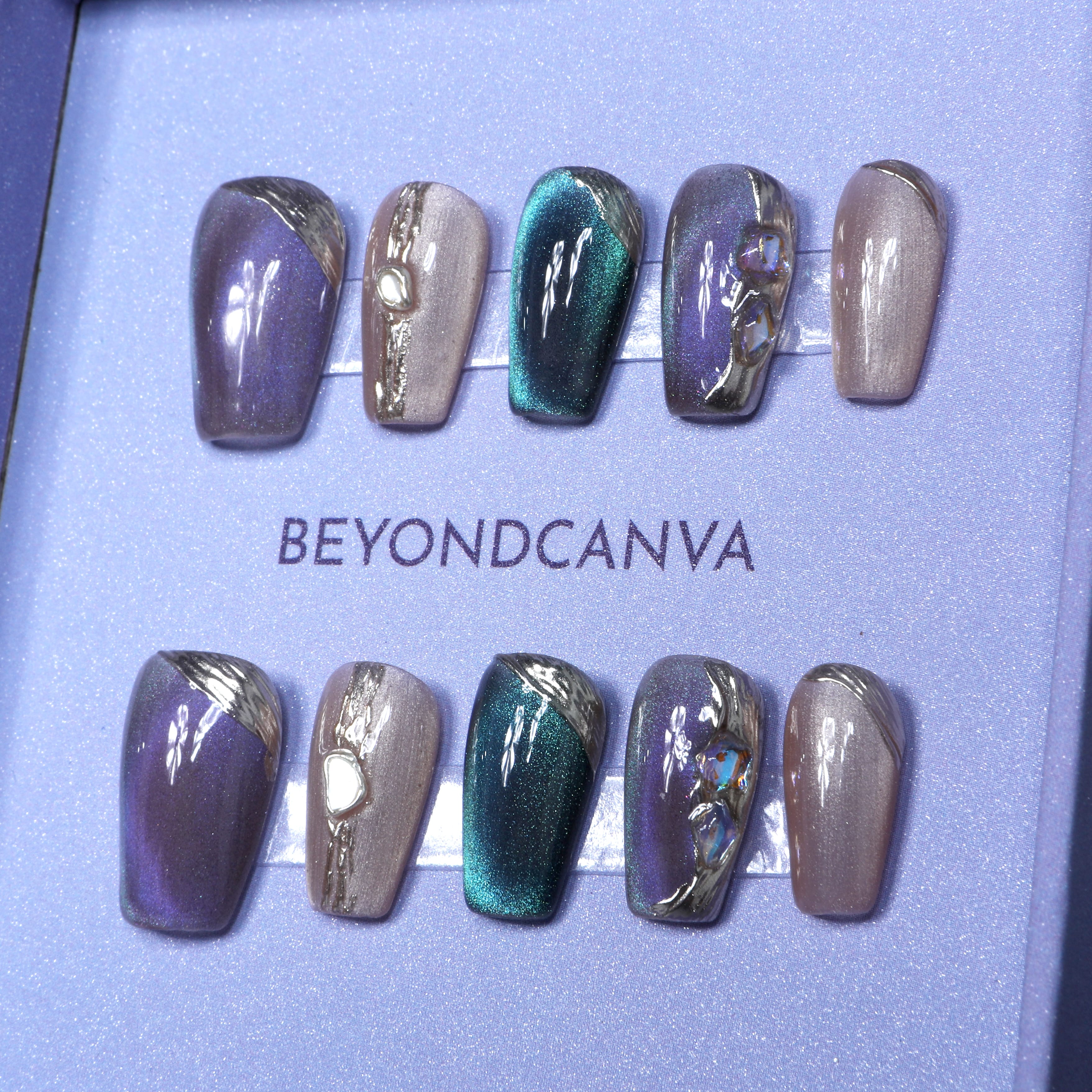 beyondcanva press-on nails in an iridescent purple and green design, adorned with pearl-like accents and textured details.