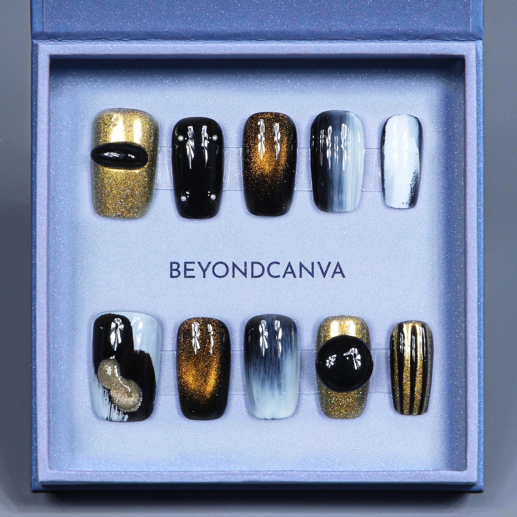 This beyondcanva press-on nail set features bold black, gold, and white tones with shimmering accents for a luxurious statement.