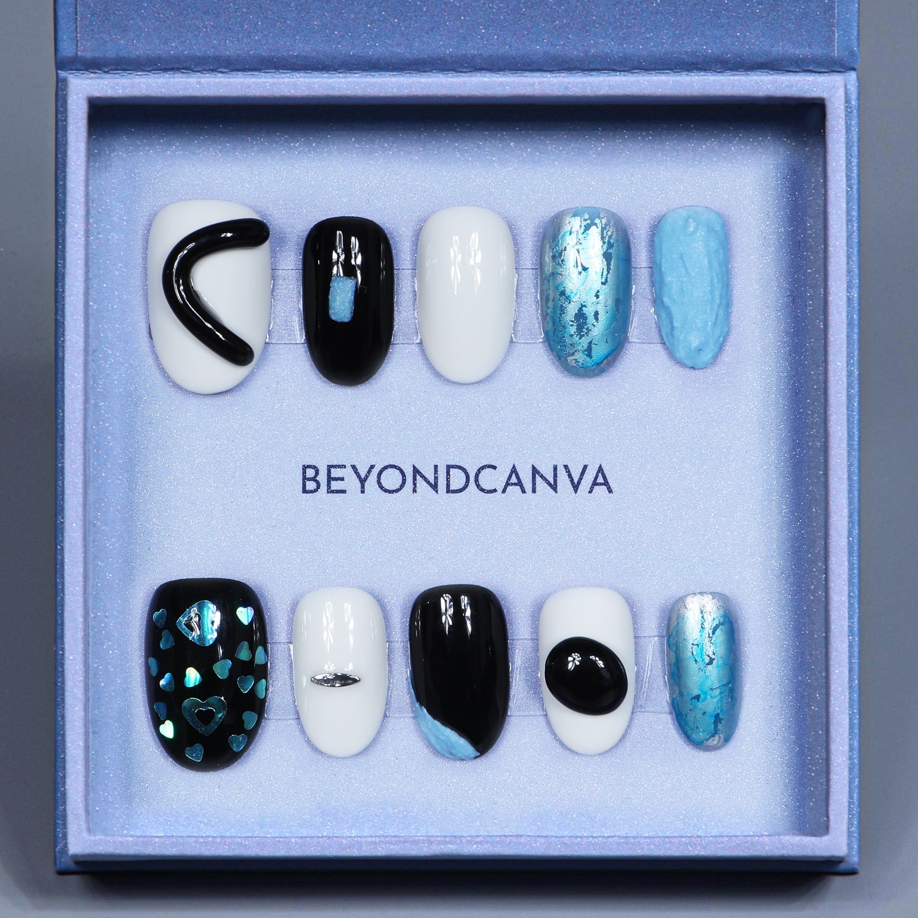 This beyondcanva press-on nail set features striking black, white, and blue tones with unique textures and holographic accents. Perfect for a bold, modern look.