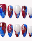 Set of press-on nails with blue, red, and white abstract swirls on a white background.