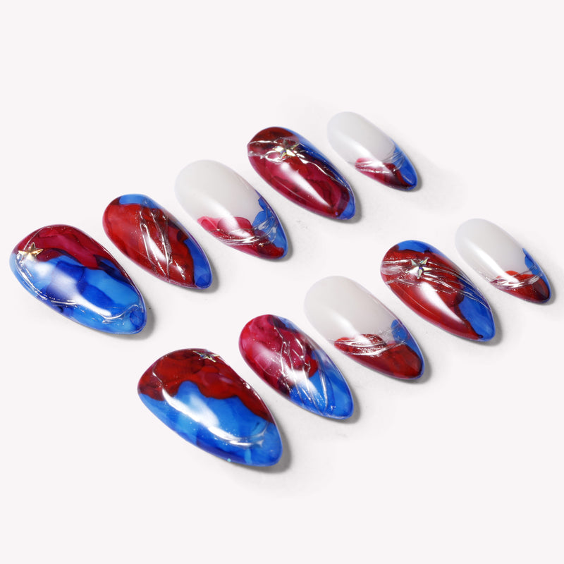 Set of press-on nails with blue, red, and white abstract swirl designs on a white background.