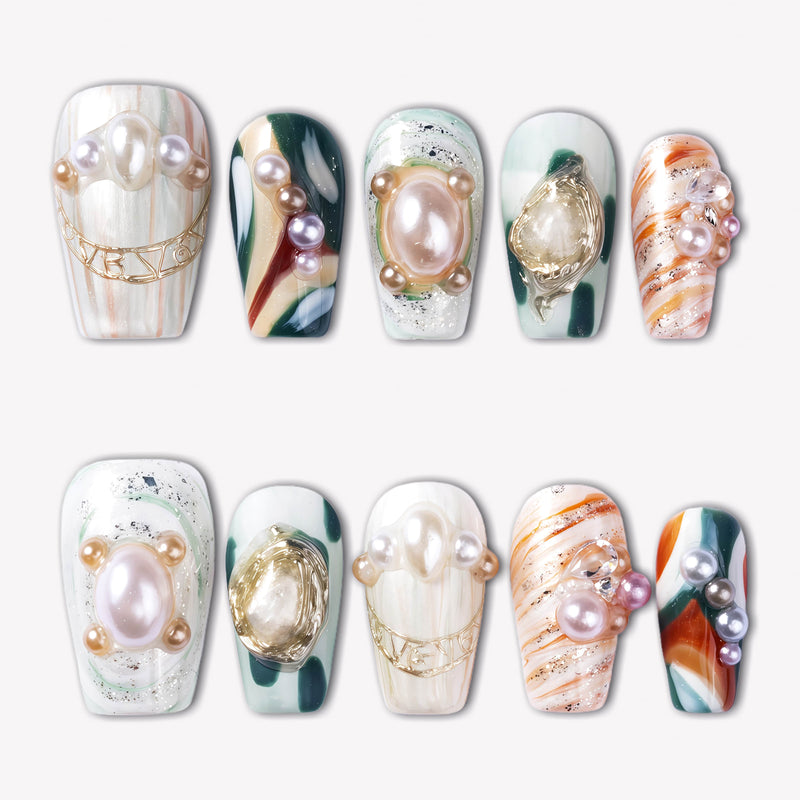 Aqua Relic press-on nails with pearl accents, gold shell charms, sea green details, and orange marble patterns