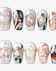 Aqua Relic press-on nails with pearl accents, gold shell charms, sea green details, and orange marble patterns
