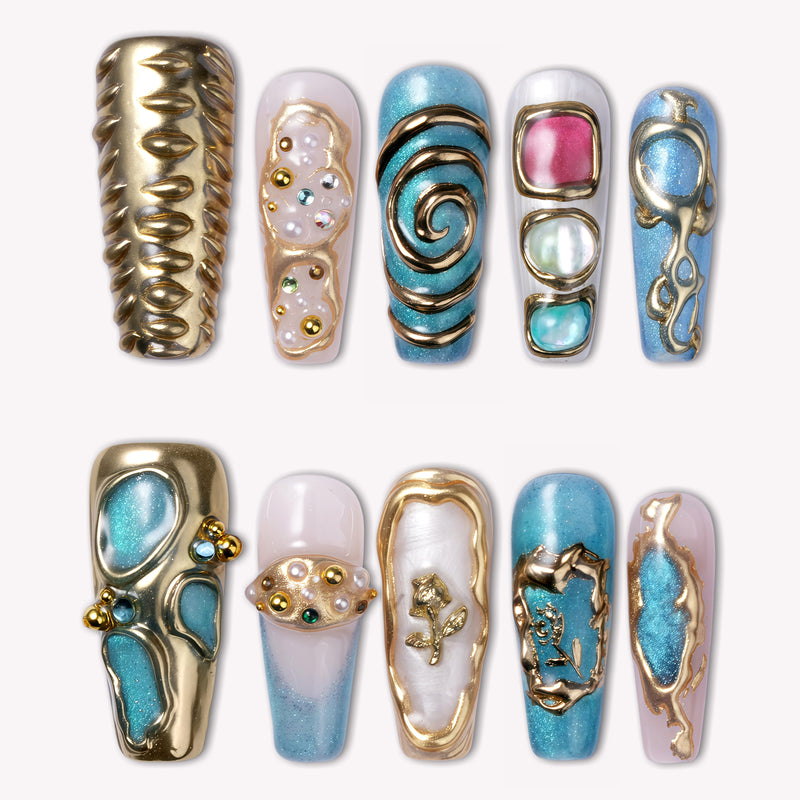Aurelia turquoise, pearl and gold sculpted press-on nails with jewel and spiral accents arranged in a flat lay