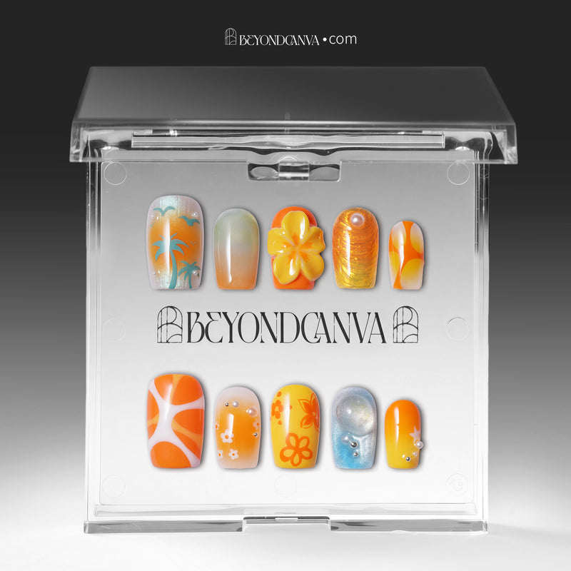 Clear acrylic packaging display showing the orange, yellow, blue, and gold press-on nail set inside a branded case.