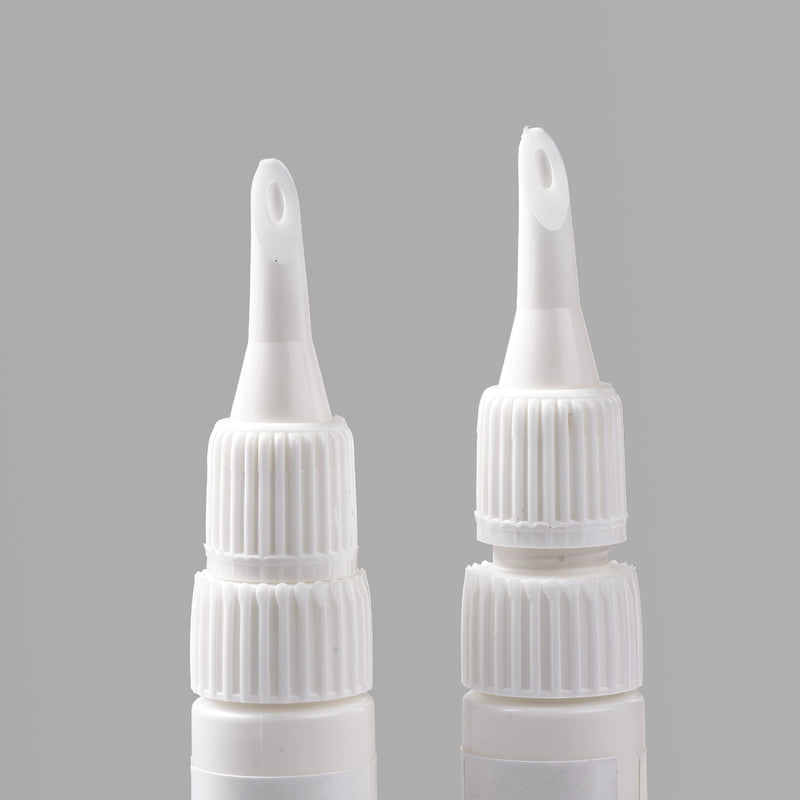 Close-up detail of two Beyondcanva glue remover pen nozzles on a gray background