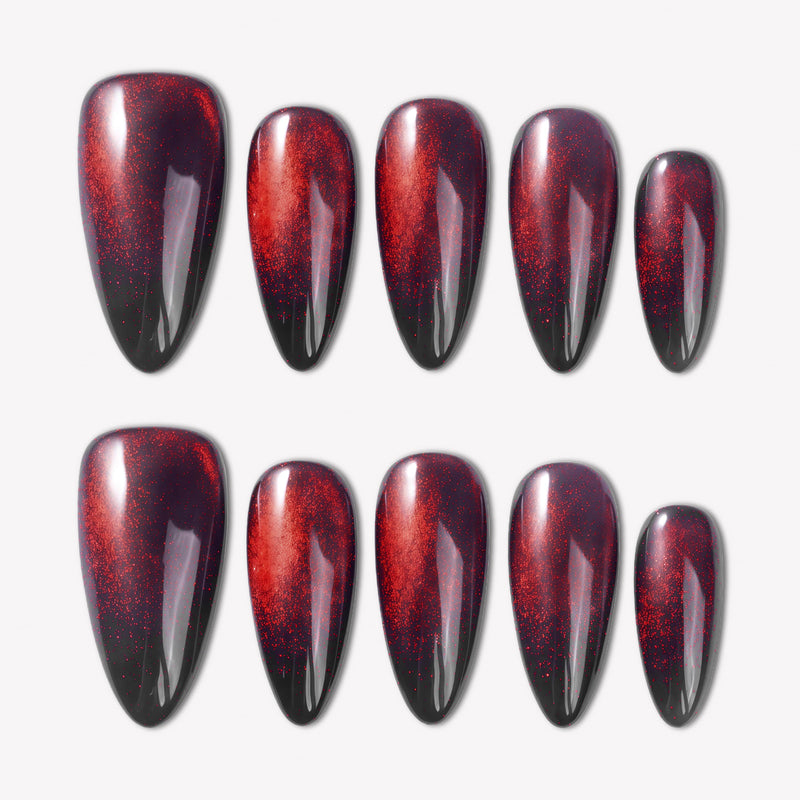 Bloody Tears press-on nails with glossy black bases, deep red cat eye shimmer, smoky blood-red gradient, and almond shapes