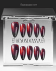 Packaging display of Bloody Tears press-on nails in a clear Beyondcanva case with glossy black bases, deep red cat eye shimmer, smoky blood-red gradient, and almond shapes