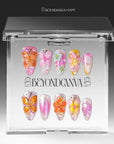 Bloom Pop pink butterfly and flower press-on nails arranged inside a clear Beyondcanva display case