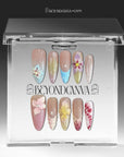 Press-on nails displayed in a clear BeyondCanva case with multicolor floral designs and pastel accent nails.