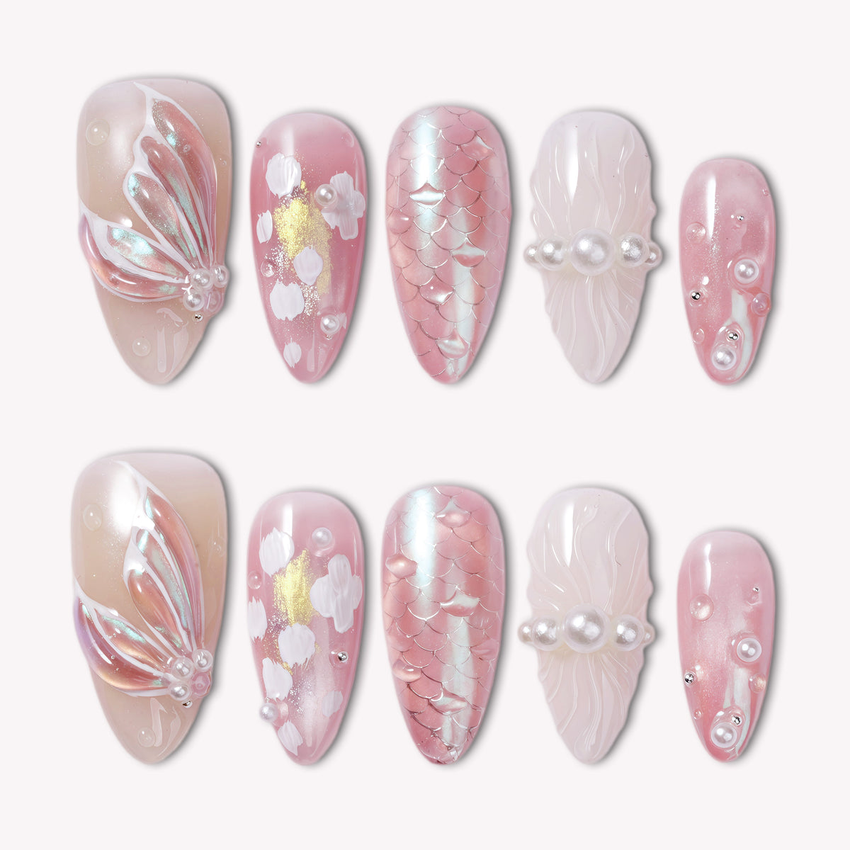 Pink press-on nails displayed in two rows with pearly accents and floral details on a white background.
