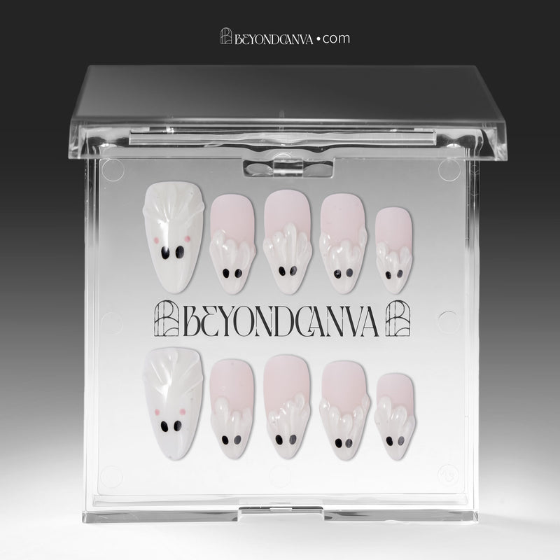 Packaging display of Boo Cuties press-on nails with pale pink bases, white ghost tips, black eyes, and pink cheeks in a clear BeyondCanva case