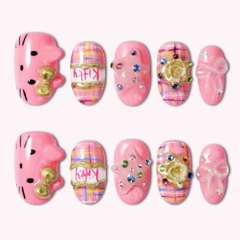 Bubblegum Pop Arcade handmade press-on nails in pink with plaid, gold accents, gems, and a bow on a white background.