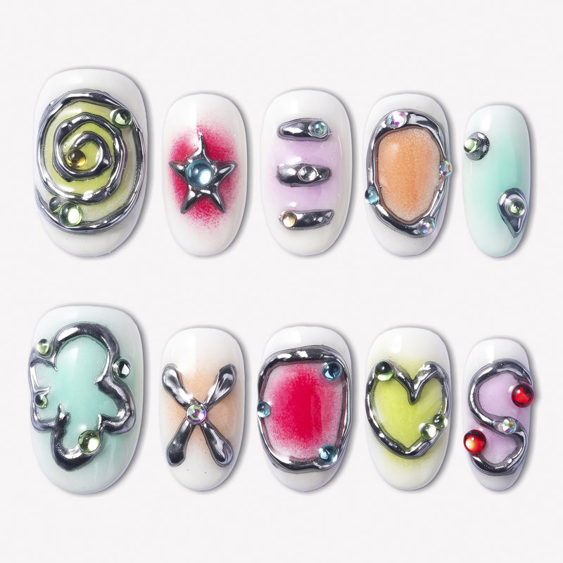 Candy Chrome press-on nails with silver chrome outlines, pastel candy colors, heart star and bow designs, glossy accents, and rhinestone details