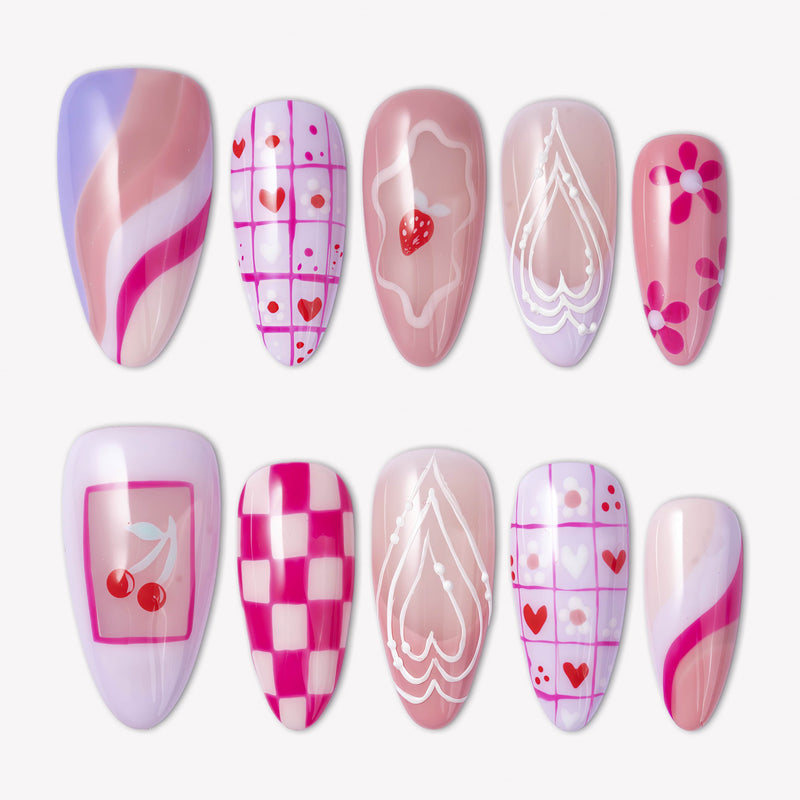 Candy Crush press-on nails with pink and purple candy colors, heart grid patterns, cherries, flowers, swirls, and white line art details