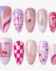 Candy Crush press-on nails with pink and purple candy colors, heart grid patterns, cherries, flowers, swirls, and white line art details
