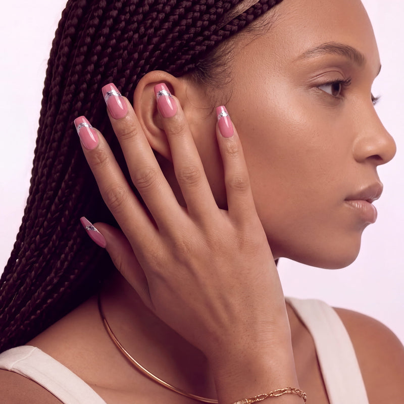 Hand model wearing Candy Spark pink press-on nails in a side profile pose