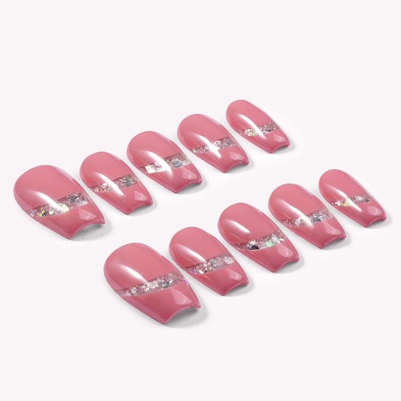 Candy Spark pink press-on nails arranged in a flat lay with silver glitter accents on a white background