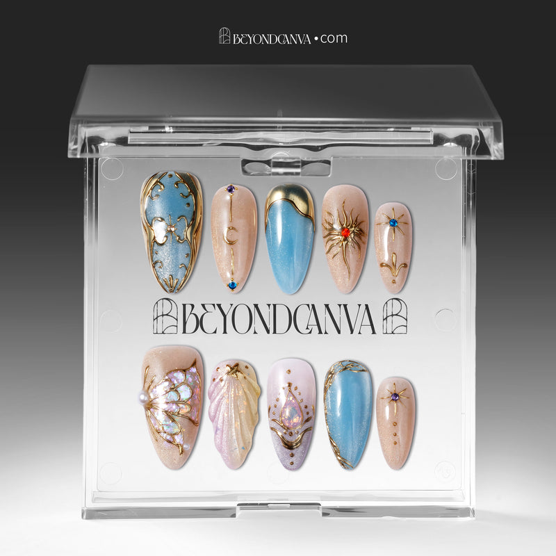 Press-on nails displayed inside a clear BeyondCanva case with blue, champagne, and gold celestial designs