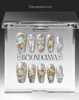 Celestial Tide press-on nails displayed in a clear Beyondcanva packaging case with silver glitter, gold swirls, and pearl accents inside