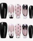 Chérie Noir press-on nails with glossy black nails, nude pink bases, black polka dots, black French outline, and raised black and white bow designs