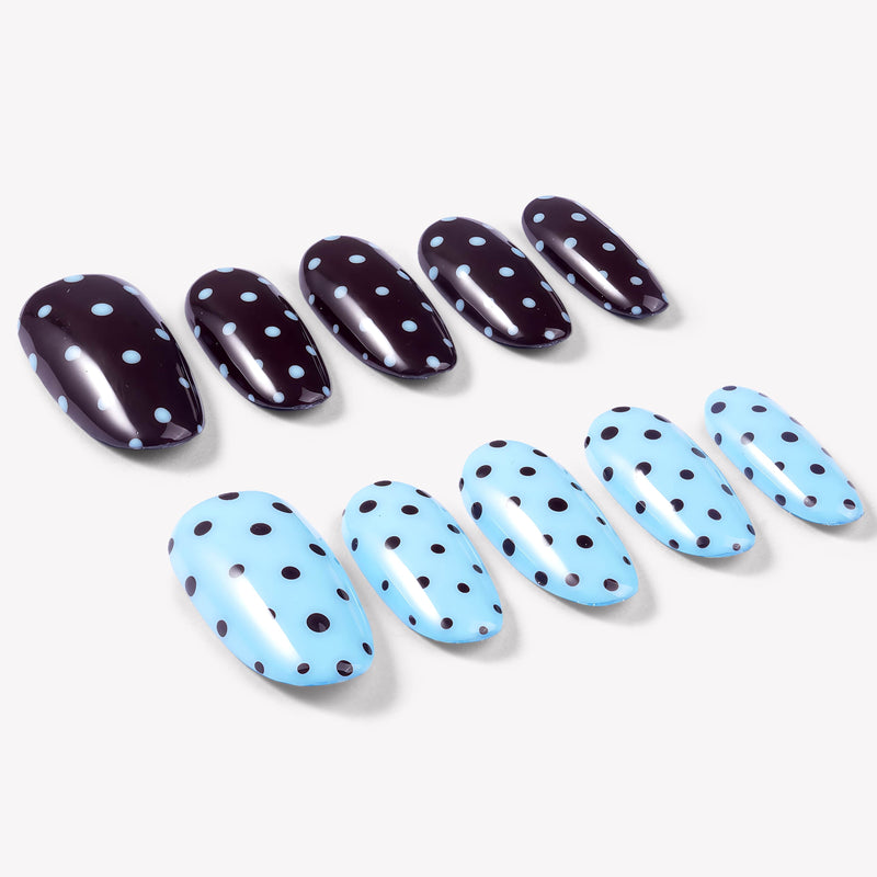 Angled flat lay of Choco Sky Dots press-on nails with glossy chocolate brown and sky blue bases plus contrasting polka dots