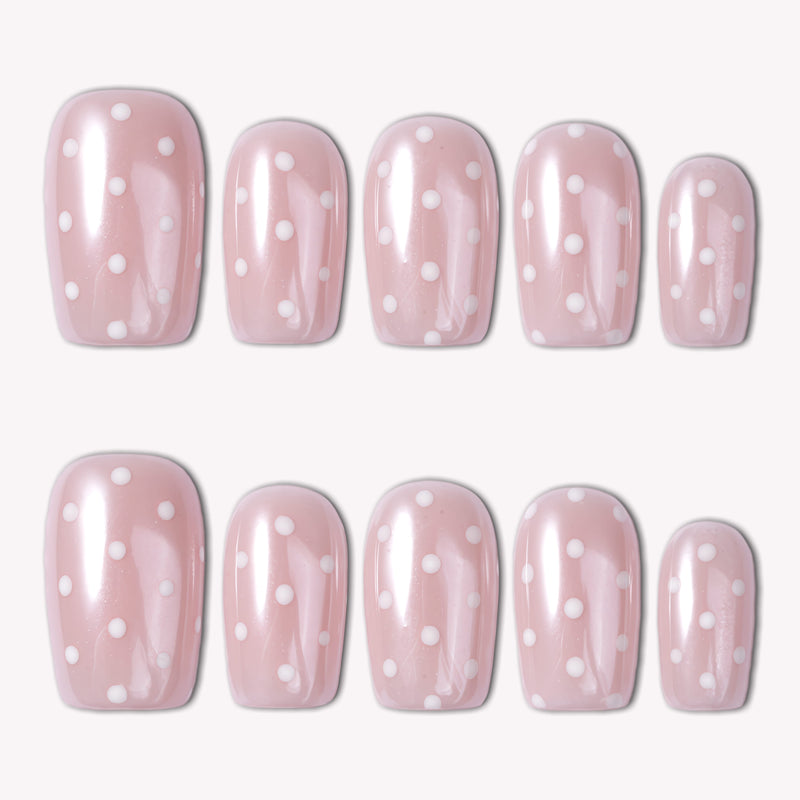 Classic Daily Set press-on nails shown in a flat lay with glossy pink nails and white polka dots on a white background