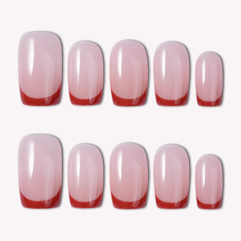 Classic Daily Set press-on nails shown as a flat lay with glossy pale pink nails and red French tips on a white background
