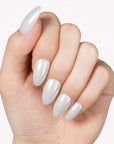 Classic Daily Set press-on nails worn in a close-up hand pose with glossy white almond-shaped nails