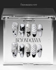 Coco Dot Affair press-on nails displayed in a clear BeyondCanva case with black and white polka dots, bows, lace, and pearl accents