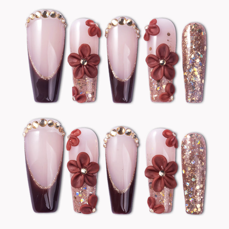 Coffee Blossom press-on nails with glossy nude and brown French tips, 3D coffee-red flowers, rhinestones, and glitter accents