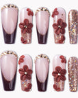 Coffee Blossom press-on nails with glossy nude and brown French tips, 3D coffee-red flowers, rhinestones, and glitter accents