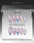 Colorful Harvest press-on nails displayed in a clear BeyondCanva case with pastel pink, lavender, blue, yellow, and fruit accents