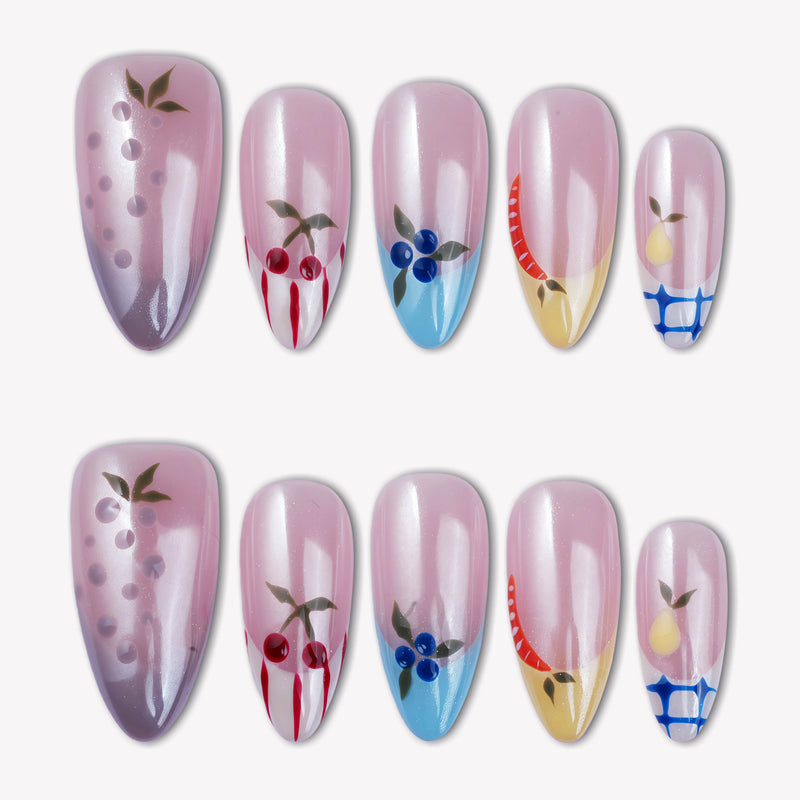 Flat lay of Colorful Harvest press-on nails with pastel pink, lavender, blue, yellow, and fruit accents arranged in two rows