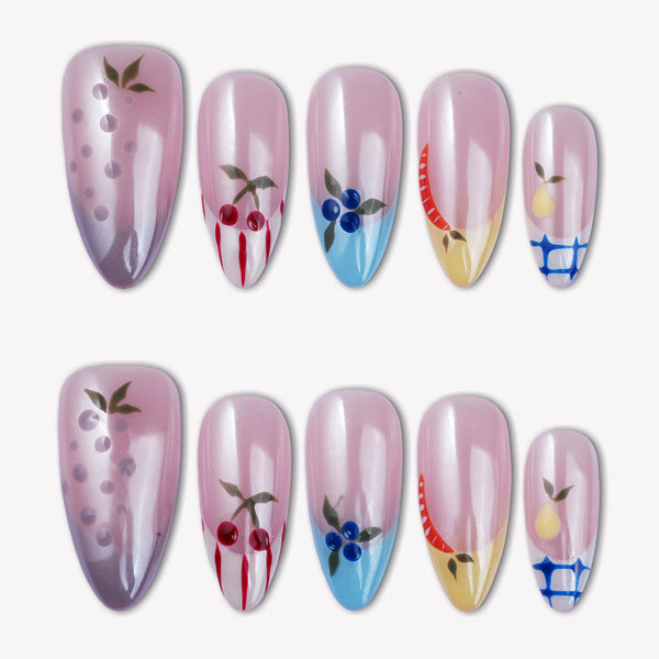 Flat lay of Colorful Harvest press-on nails with pastel pink, lavender, blue, yellow, and fruit accents arranged in two rows