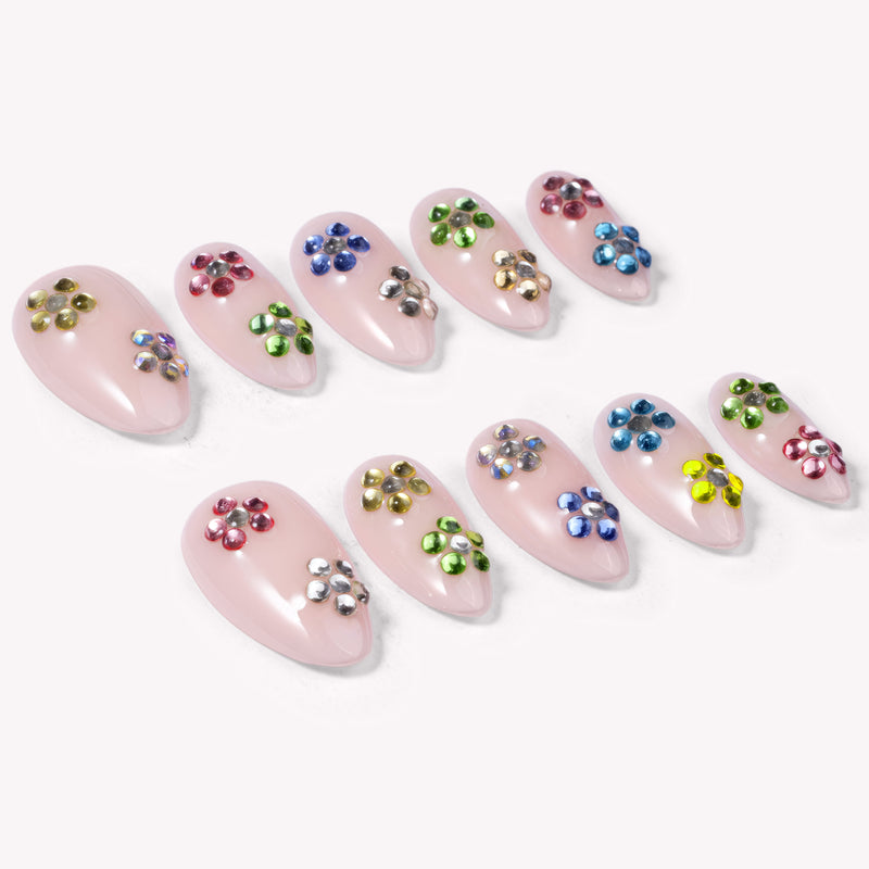 Crystal Dew handmade press on nails arranged in a white flat lay showing the full colorful rhinestone set