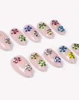 Crystal Dew handmade press on nails arranged in a white flat lay showing the full colorful rhinestone set