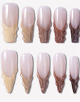 Dance of Shifting Sands press-on nails with glossy nude bases and sand to brown sculpted wave accents arranged in a full set