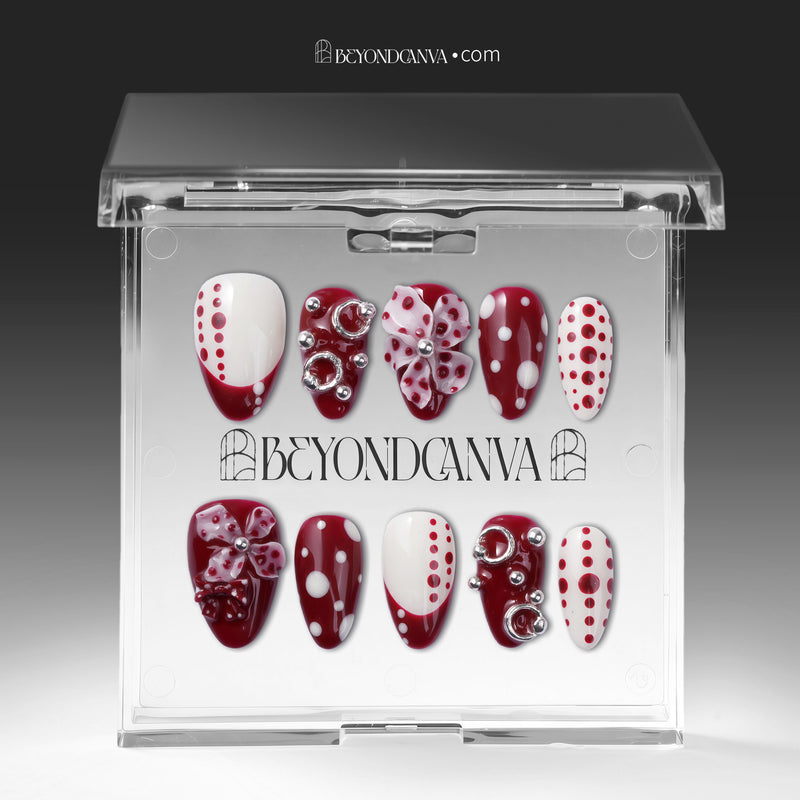 Dot Fantasy press-on nails in red and white with polka dots and jeweled 3D accents displayed in a clear packaging box
