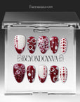 Dot Fantasy press-on nails in red and white with polka dots and jeweled 3D accents displayed in a clear packaging box