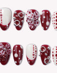 Dot Fantasy press-on nail set in red and white with polka dots and jeweled 3D accents arranged on a white background