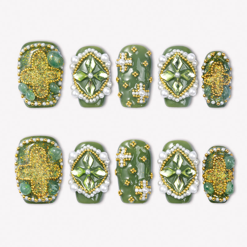 Emerald Crown press-on nails with glossy green bases, faceted green gems, pearl borders, gold beads, and glitter accents